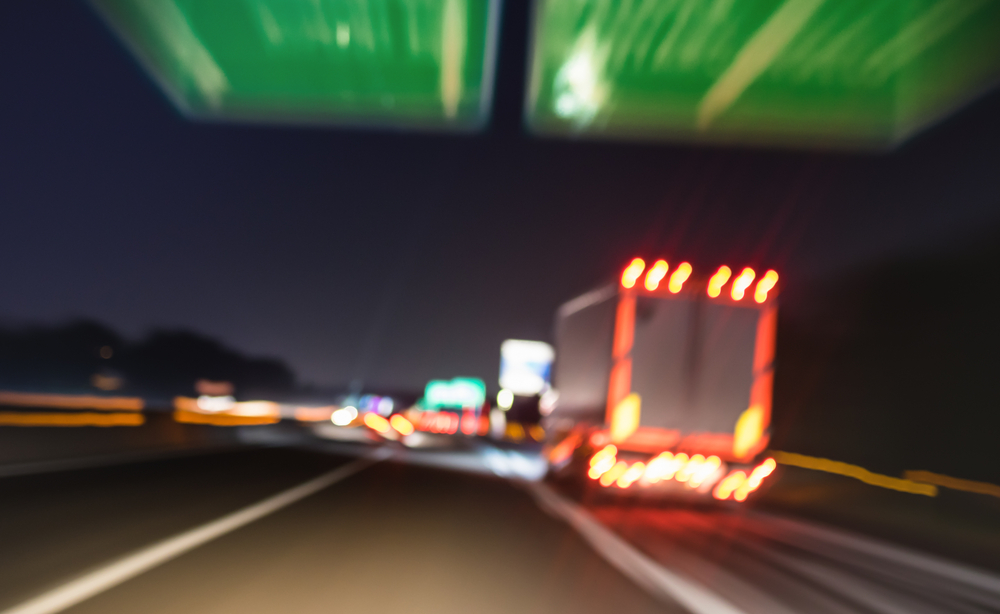 trucks speeding down the interstate at night