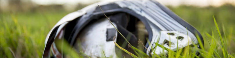 motorcycle helmet laying in grass indicating there was a motorcycle accident