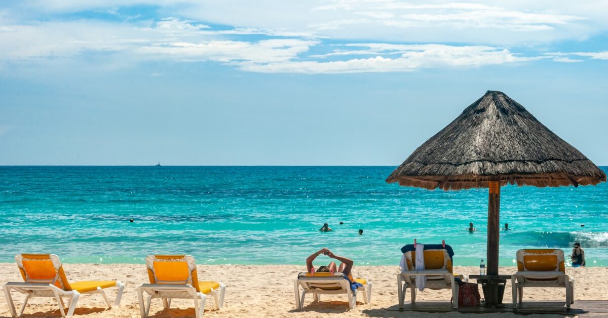 brown beach umbrellas on beach during daytime